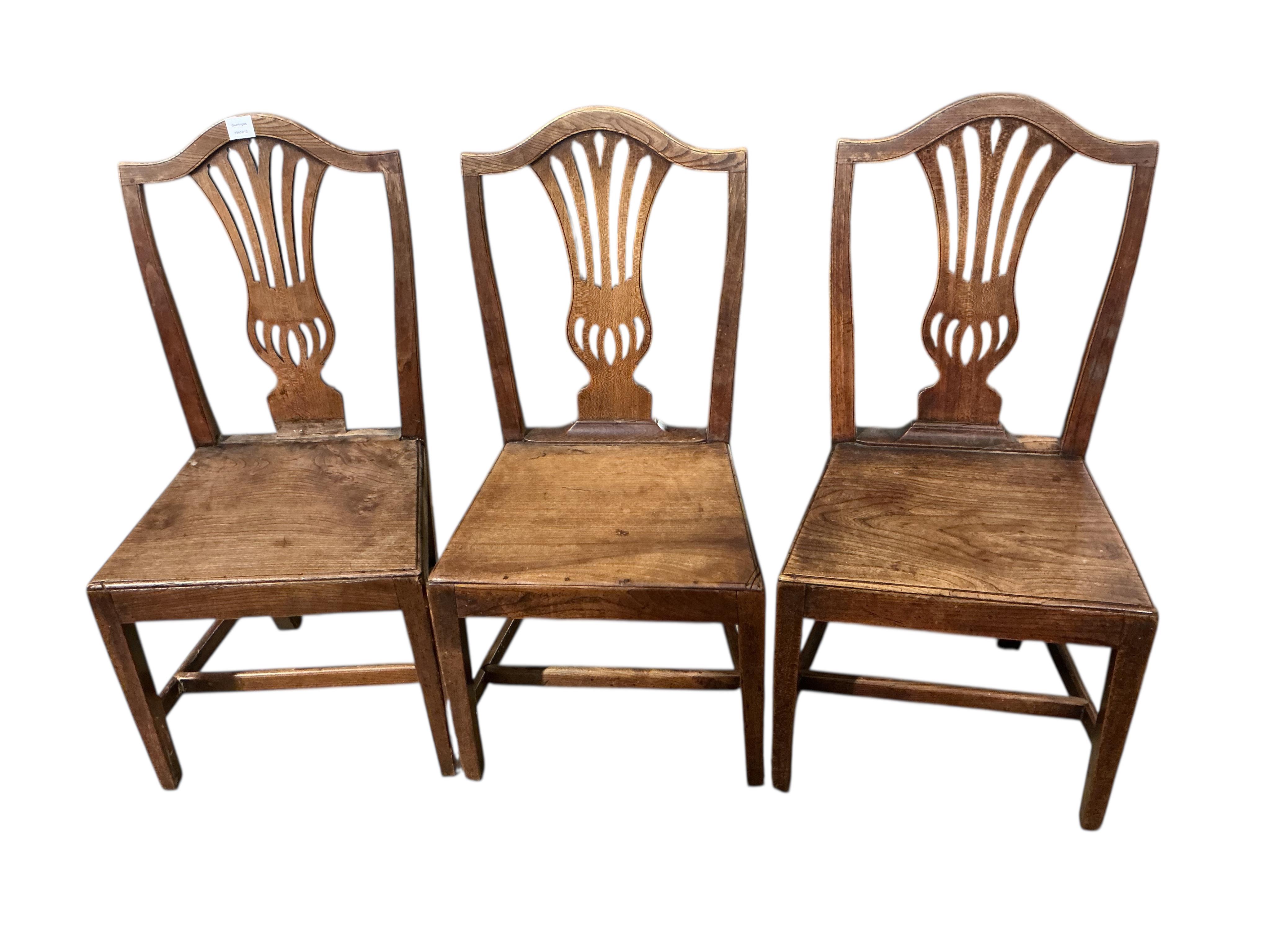 A set of three George III Provincial elm dining chairs, width 49cm, height 99cm